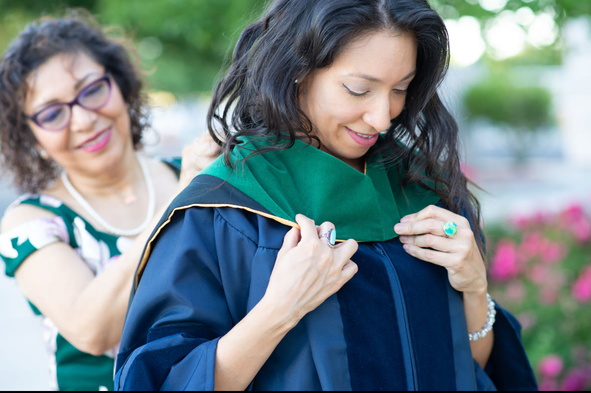 Dr. Gigi Magan's mother placing her graduation hood