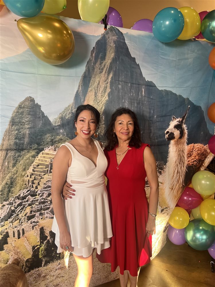 Celebrating with my mom in front of a Machu Picchu backdrop